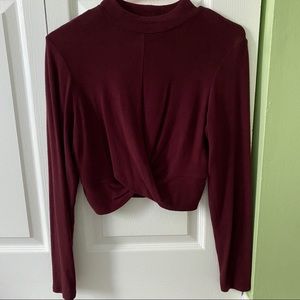 Long sleeve burgundy crop top with twist front.